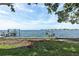 Waterfront backyard featuring grassy lawn and private boat dock for waterfront living at 2650 W Bay Isle Se Dr, St Petersburg, FL 33705