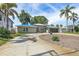 Inviting single-Gathering home features mature landscaping, a circular driveway, and a two-car garage at 2650 W Bay Isle Se Dr, St Petersburg, FL 33705