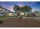 Charming home with a gray exterior, circular driveway, and manicured landscaping at 2650 W Bay Isle Se Dr, St Petersburg, FL 33705