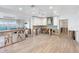 Contemporary kitchen features white cabinets, stainless hood, and open layout to the living room at 2650 W Bay Isle Se Dr, St Petersburg, FL 33705