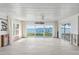 Bright living room features wood-look floors and expansive windows offering stunning water views at 2650 W Bay Isle Se Dr, St Petersburg, FL 33705