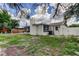 Backyard view featuring a door, fence, and a well-maintained lawn at 3025 Palamore Dr, Holiday, FL 34691