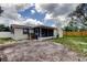 Backyard view showing the home's exterior, enclosed porch and fence at 3025 Palamore Dr, Holiday, FL 34691