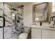 Stylish bathroom with a glass shower, marble accents, and a white vanity at 3025 Palamore Dr, Holiday, FL 34691