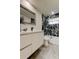 Updated bathroom featuring marble tile in shower with glass doors, modern vanity with quartz countertops at 3025 Palamore Dr, Holiday, FL 34691