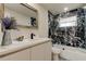 Updated bathroom with marble tile in shower and glass doors, quartz countertops, and modern vanity at 3025 Palamore Dr, Holiday, FL 34691