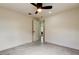 Spacious bedroom featuring neutral walls, gray tile flooring, and a modern ceiling fan at 3025 Palamore Dr, Holiday, FL 34691