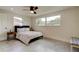 Bright bedroom with light gray floors, ceiling fan, and windows providing natural light at 3025 Palamore Dr, Holiday, FL 34691