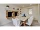 Dining area boasts a decorative fireplace, a modern table set, and natural light from the door at 3025 Palamore Dr, Holiday, FL 34691