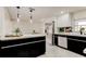 Open kitchen layout with stainless steel appliances, quartz countertops, black marble backsplash, and eat-in bar at 3025 Palamore Dr, Holiday, FL 34691