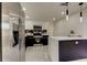 Modern kitchen features stainless steel appliances, black and white cabinets, and stylish pendant lighting at 3025 Palamore Dr, Holiday, FL 34691