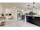Modern kitchen with stainless steel appliances, white cabinetry, and an adjacent dining area at 3025 Palamore Dr, Holiday, FL 34691