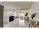 Open-concept living area with gray tile flooring, opening to the kitchen with island seating at 3025 Palamore Dr, Holiday, FL 34691