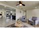 Open-concept living room showcasing gray tile flooring, modern decor, and seamless access to the kitchen at 3025 Palamore Dr, Holiday, FL 34691