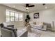 Bright living room featuring a large bay window, plush seating, and stylish decor at 3025 Palamore Dr, Holiday, FL 34691