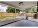 Enclosed sunroom with views of the fenced backyard and modern light fixture at 3025 Palamore Dr, Holiday, FL 34691