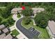 An aerial view shows townhomes with guest parking and green space and mature landscaping at 3110 Royal Tuscan Ln, Valrico, FL 33594
