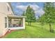 Expansive backyard featuring a screened-in lanai, lush green lawn, and mature trees at 3110 Royal Tuscan Ln, Valrico, FL 33594