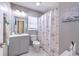 Bathroom featuring decorative seashell shower curtain, single vanity, and a white marble floor at 3110 Royal Tuscan Ln, Valrico, FL 33594