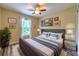 Cozy bedroom with a plush bed, decorative pillows, and scenic art for a soothing aesthetic at 3110 Royal Tuscan Ln, Valrico, FL 33594
