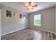 Spacious bedroom with stylish wood-look floors, ceiling fan and a bright window view at 3110 Royal Tuscan Ln, Valrico, FL 33594