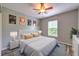 Bedroom featuring wood-look floors, a ceiling fan, and natural light from the window at 3110 Royal Tuscan Ln, Valrico, FL 33594