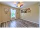Inviting bedroom with wood-look flooring, natural light, and classic wall art at 3110 Royal Tuscan Ln, Valrico, FL 33594