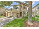 Charming two-story home features a well-manicured lawn, beautiful landscaping, and an attached two-car garage at 3110 Royal Tuscan Ln, Valrico, FL 33594