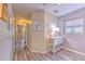 Hallway with wood-look flooring and natural light from the window with console table at 3110 Royal Tuscan Ln, Valrico, FL 33594