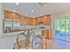 The open kitchen features stainless appliances, granite countertops, and counter seating at 3110 Royal Tuscan Ln, Valrico, FL 33594