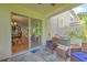 The cozy lanai featuring comfortable seating opens to the living area via sliding glass doors at 3110 Royal Tuscan Ln, Valrico, FL 33594