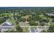 The overhead perspective highlights the home's position nestled among trees and neighboring properties in a tranquil setting at 3212 Cork Rd, Plant City, FL 33565