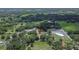 Aerial view of a single-Gathering residence with various outbuildings, complemented by mature trees and green spaces at 3212 Cork Rd, Plant City, FL 33565