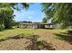 Expansive backyard featuring lush greenery, mature trees, and a covered carport that offers ample space for outdoor activities at 3212 Cork Rd, Plant City, FL 33565