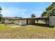 View of the backyard with a covered parking area attached to the house at 3212 Cork Rd, Plant City, FL 33565