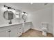 Bright bathroom features double sinks, modern fixtures, and wood floors at 3212 Cork Rd, Plant City, FL 33565