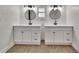 Modern bathroom features double sinks, quartz counters, and wood floors at 3212 Cork Rd, Plant City, FL 33565