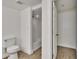 Bright bathroom showcasing a toilet, wood floors, and a shower with white subway tiles at 3212 Cork Rd, Plant City, FL 33565