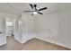 Bright bedroom features new floors, fresh paint, a ceiling fan and an ensuite bath at 3212 Cork Rd, Plant City, FL 33565