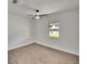 This bright bedroom features wood floors, natural light, and modern ceiling fan at 3212 Cork Rd, Plant City, FL 33565