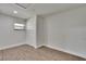 A minimalist bedroom with wood floors, a closet, a window, and white walls at 3212 Cork Rd, Plant City, FL 33565