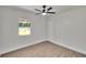 Bright bedroom features new floors, fresh paint, a ceiling fan and a window at 3212 Cork Rd, Plant City, FL 33565