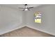 Small, minimalist bedroom featuring modern wood floors, a fan, and a window at 3212 Cork Rd, Plant City, FL 33565