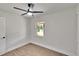 Bedroom features wood-look floors, a ceiling fan, and a bright window at 3212 Cork Rd, Plant City, FL 33565