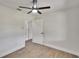 This bedroom features a ceiling fan, a window, and wood-look flooring at 3212 Cork Rd, Plant City, FL 33565