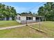 Landscaped exterior view of a single-story home featuring a fence at 3212 Cork Rd, Plant City, FL 33565