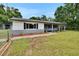 Charming home featuring a well-manicured lawn and a covered front porch at 3212 Cork Rd, Plant City, FL 33565