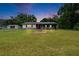 Charming single-story home features a covered porch, red front door and large front yard at 3212 Cork Rd, Plant City, FL 33565
