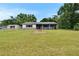 Charming single-story home with manicured front lawn and red door at 3212 Cork Rd, Plant City, FL 33565