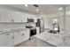 Modern kitchen boasts stainless steel appliances, white cabinets, marble countertops, and breakfast bar at 3212 Cork Rd, Plant City, FL 33565